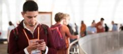 A man wearing a big ID and holding his phone